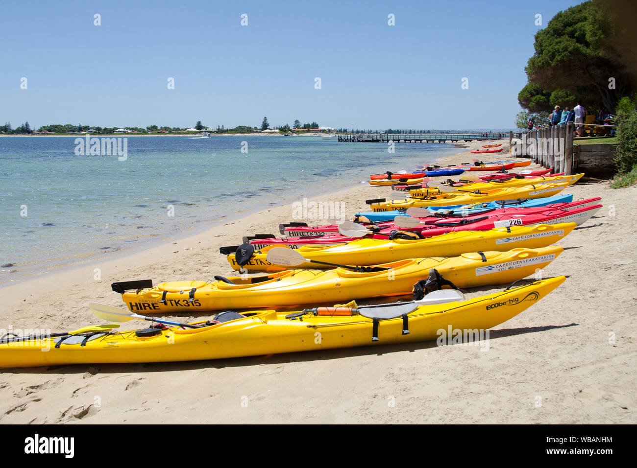 Kayaks hauled up on the beach. Limestone reefs, rocks and islets support a rich diversity and abundance of marine and terrestrial wildlife making the Stock Photo