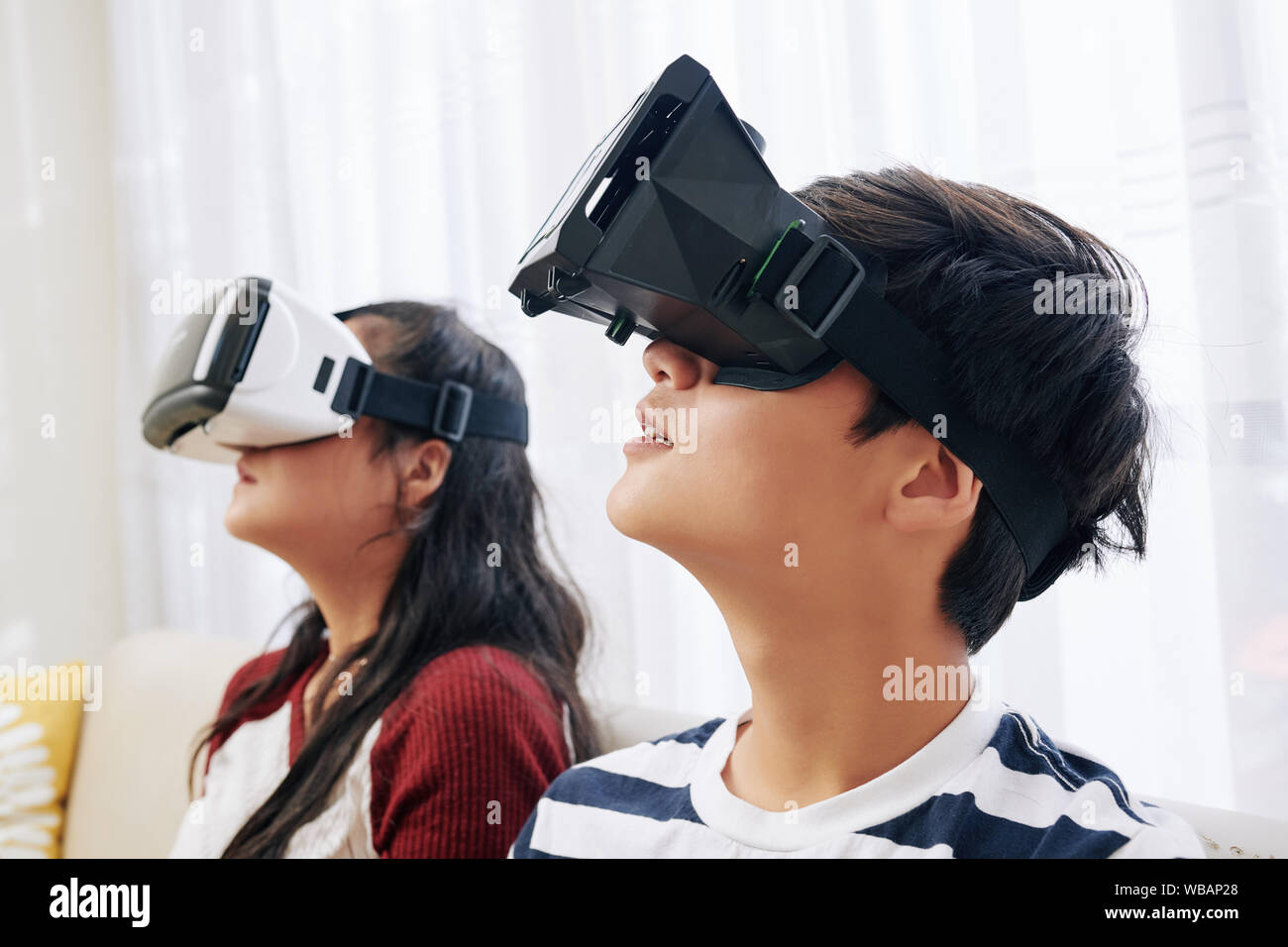 Curious children in headsets experiencing virtual reality for the first ...