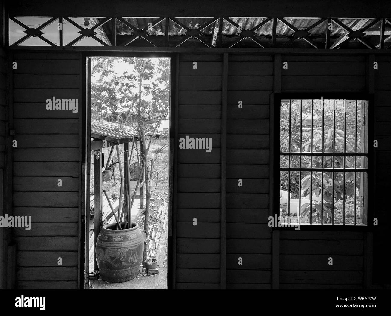 Black and white image of Empty abandoned wooden house in rural asian country with garden view Stock Photo