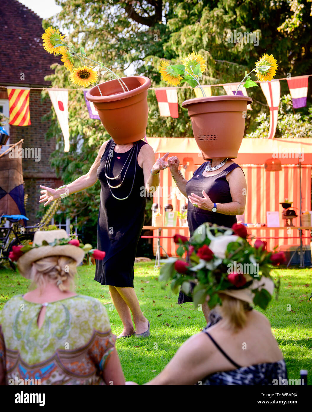 Muddles Green, UK. 25 August, 2019. Guests dress up and join the Surrealist picnic held at Farleys House and Gallery, the home of Lee Miller and Roland Penrose. In the mid-20th century, Lee Miller, Roland Penrose and their son Antony Penrose's Sussex home became a meeting place for some of the leading figures from the world of modern art. These included Pablo Picasso, Max Ernst, Joan Miro, Man Ray, Leonora Carrington, Antoni Tˆpies, Eileen Agar, Kenneth Armitage and  William Turnbull. The annual picnic continues Farleys celebration of surrealism. Picture by Jim Holden/Alamy Live News Stock Photo