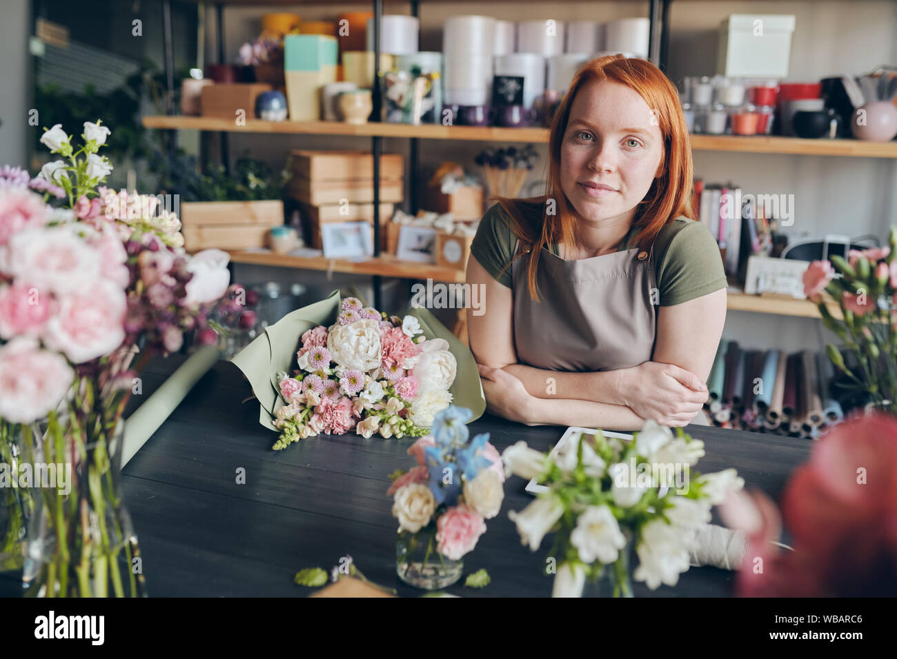 Florist in apron standing at counter Stock Photo