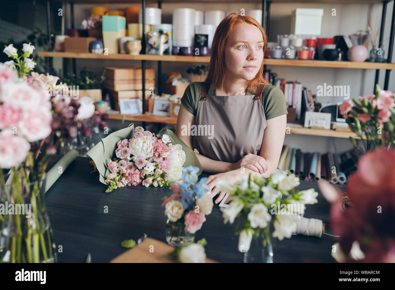 Florist waiting for customer in flower shop Stock Photo