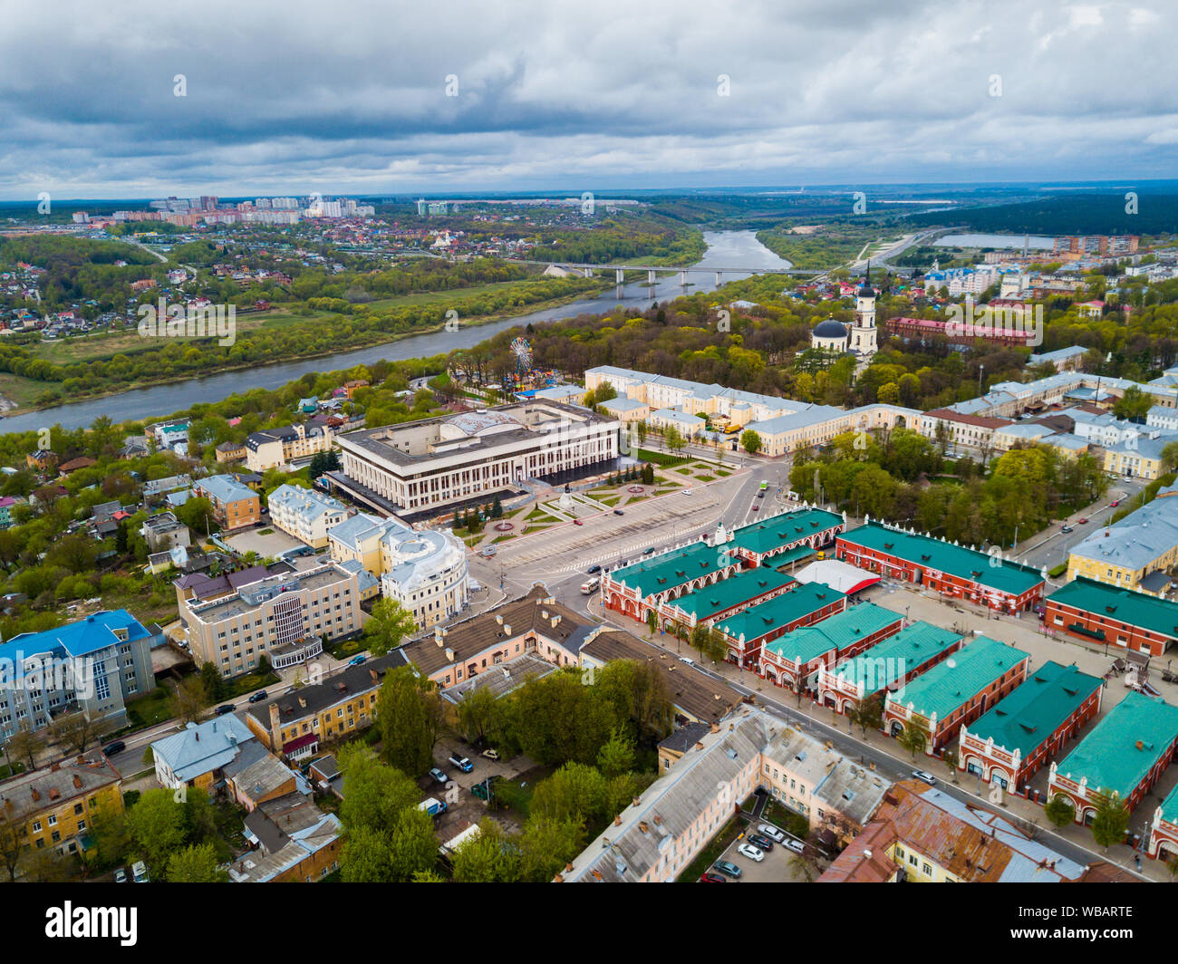 Aerial panoramic view of modern cityscape of Kaluga on banks of Oka river overlooking black domes of Holy Trinity Cathedral Stock Photo