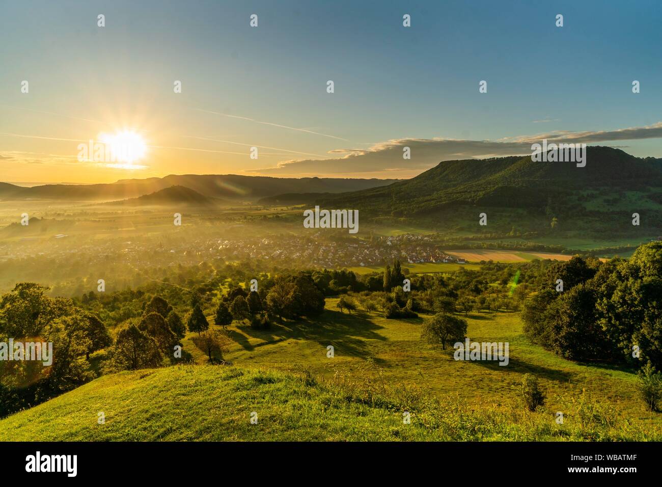 Sunrise, panoramic view, view of the village and the three imperial mountains Hohenstaufen, Rechberg and Stuifen, Bissingen, Swabian Alb Stock Photo