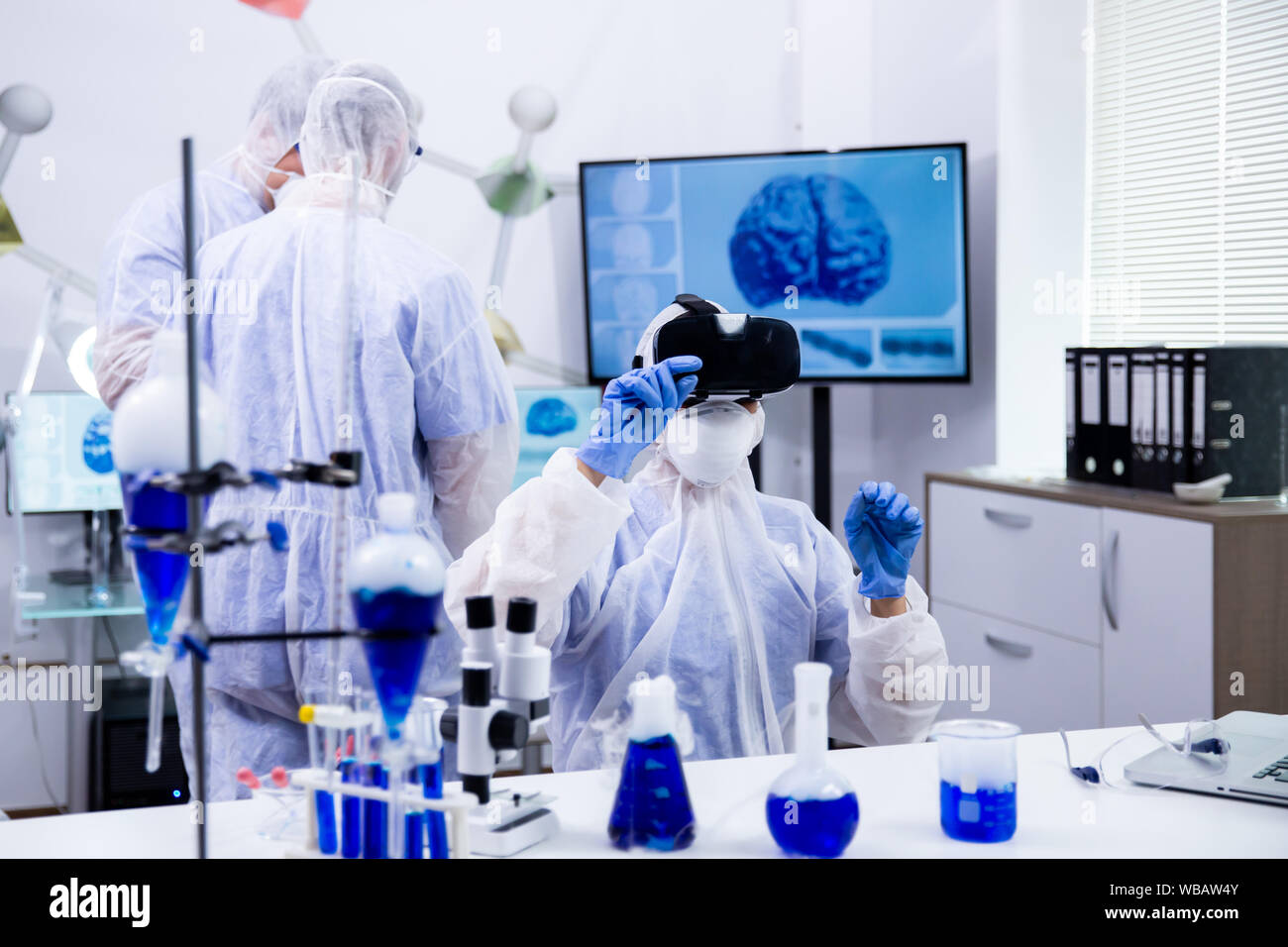 Female scientist using virtual reality simulation for scientific ...