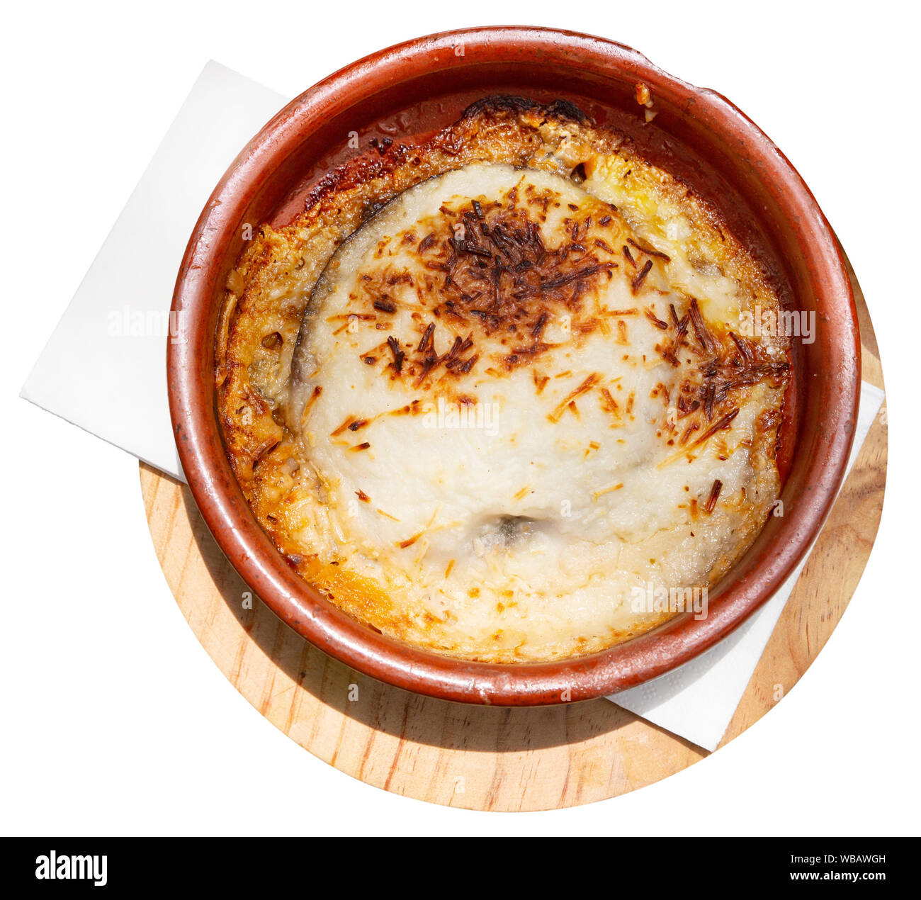 Top view of delicious Greek moussaka from baked eggplant with olive oil, meat mince and bechamel sauce served in pottery. Isolated over white backgrou Stock Photo
