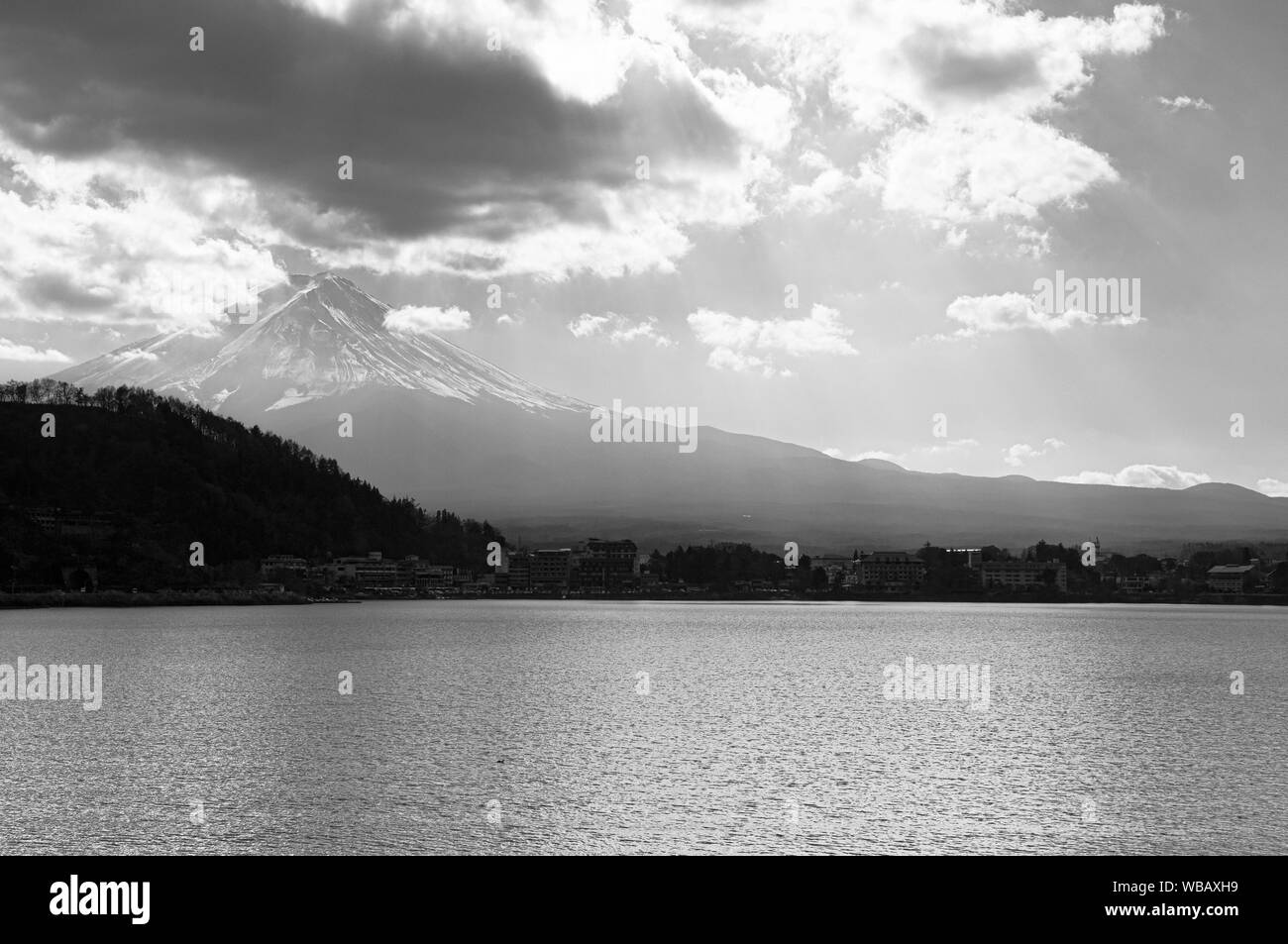 Mount Fuji behind Lake Kawaguchiko peaceful water shoreline in cold winter, black and white image. Fujikawaguchiko - Japan Stock Photo