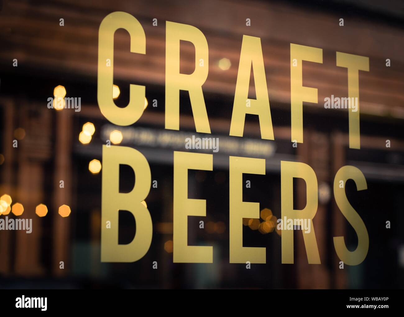 Craft Beers Sign in Pub Window With Reflection of Lights in Glasgow, Scotland. Stock Photo