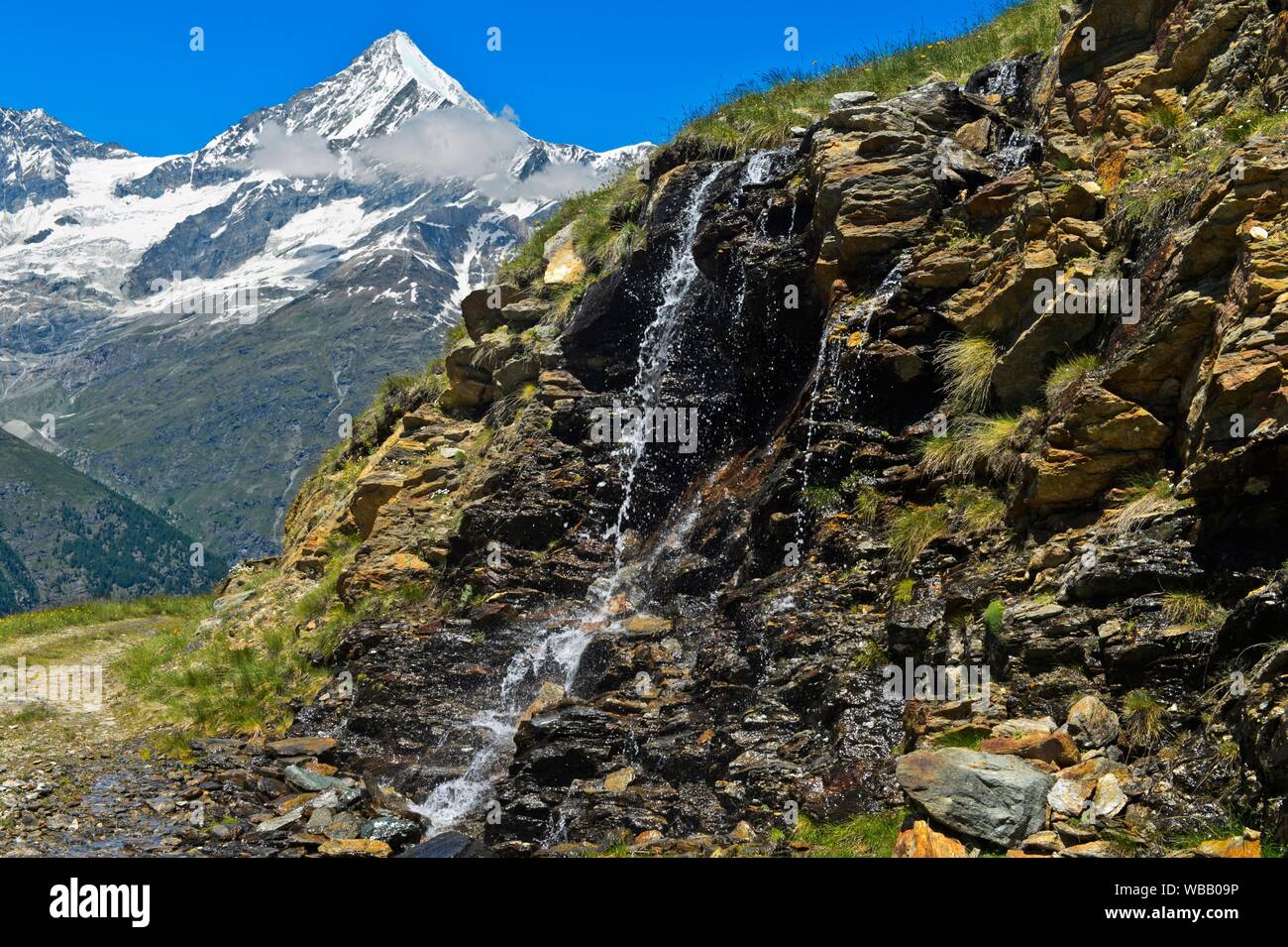 Waterfall in front of the Weisshorn peak, Taeschalp, Valais, Switzerland. Stock Photo