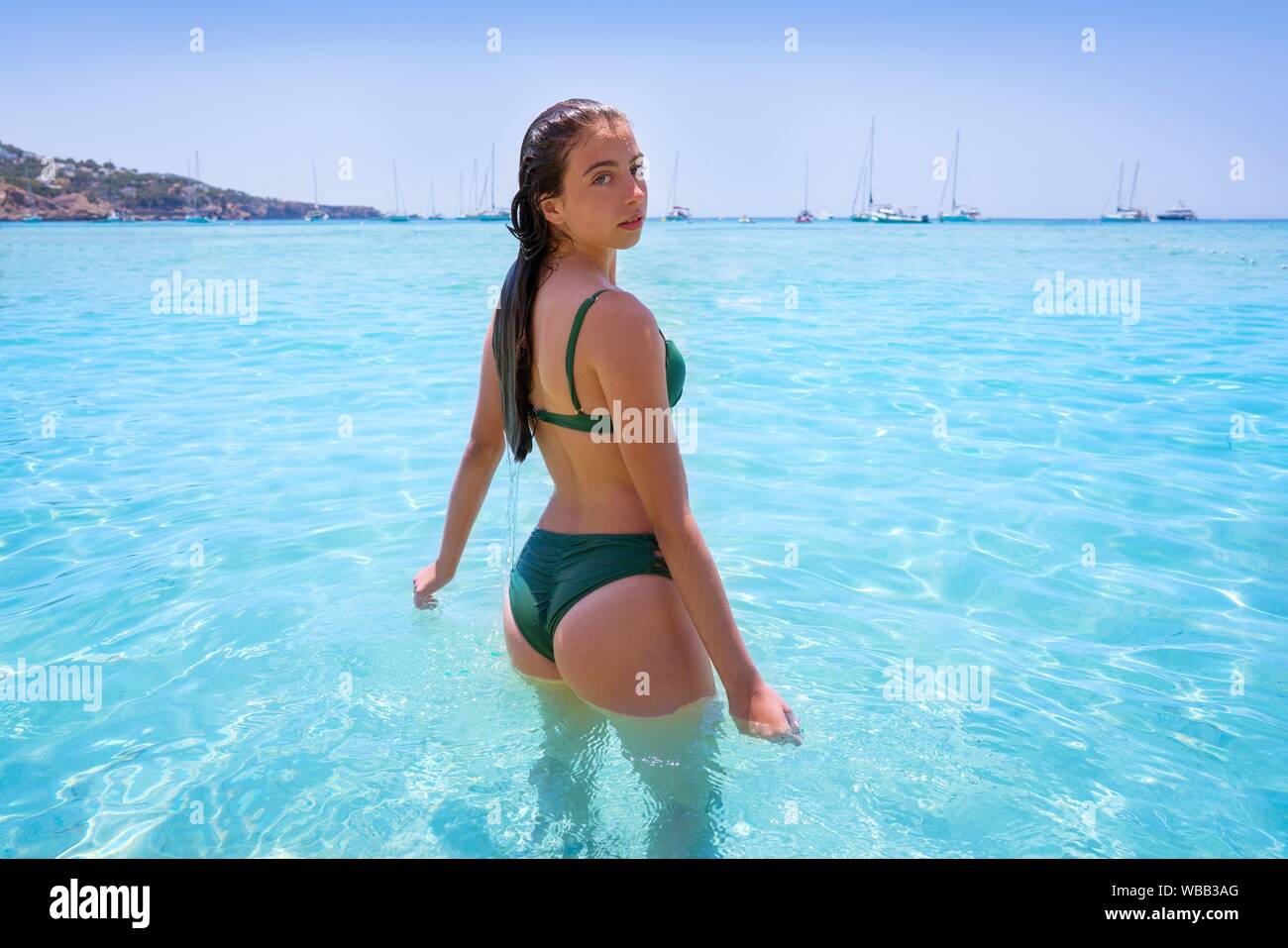 Ibiza bikini girl relaxed in clear water beach of Balearic Islands. Stock Photo