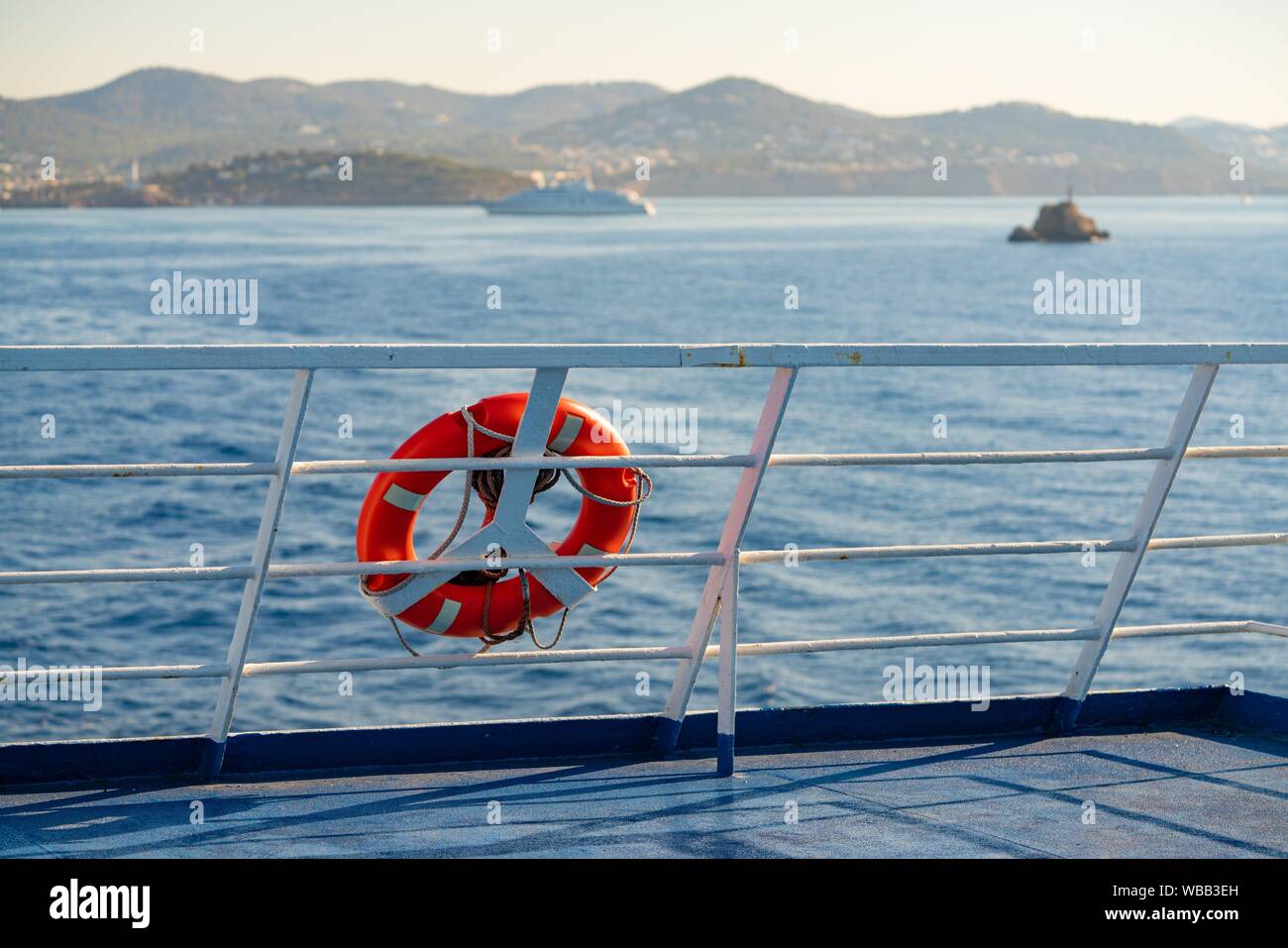 Ferry railing in Ibiza with round buoy at Mediterranean Balearics sea of Spain. Stock Photo