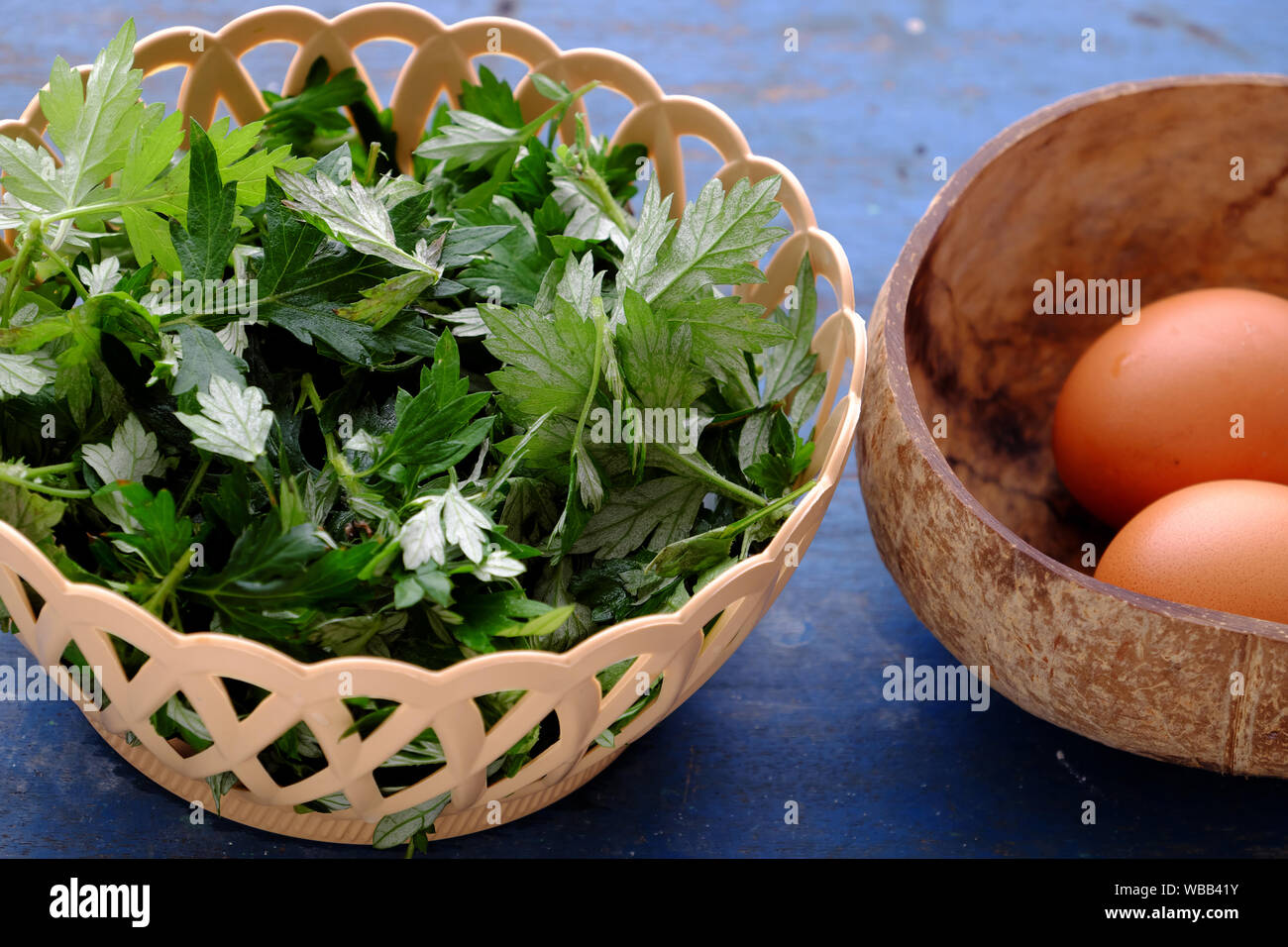 Raw materials fried egg with mugwort leaves, healthy food with 