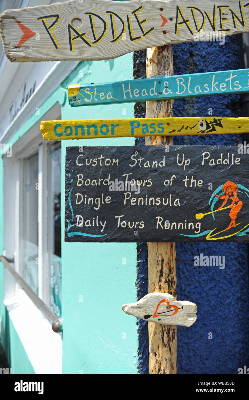 Collection of abstract signs on a timber post in Dingle, County Kerry, Republic of Ireland Stock Photo