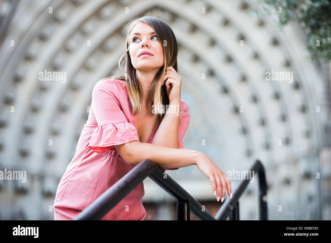 Woman Using Handrail Glad female standing on handrail of stairs at the street in Barcelona ...