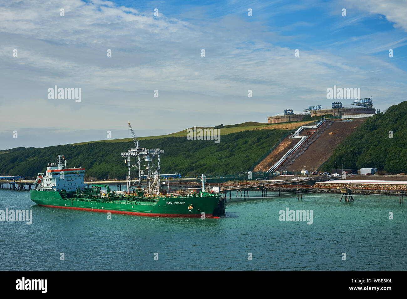 Oil and petro-chemical tankers moored to pontoons serving Milford Haven refineries in South Wales. Stock Photo