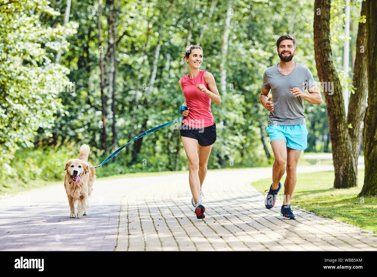 Girl running park with dog hi-res stock photography and images - Alamy