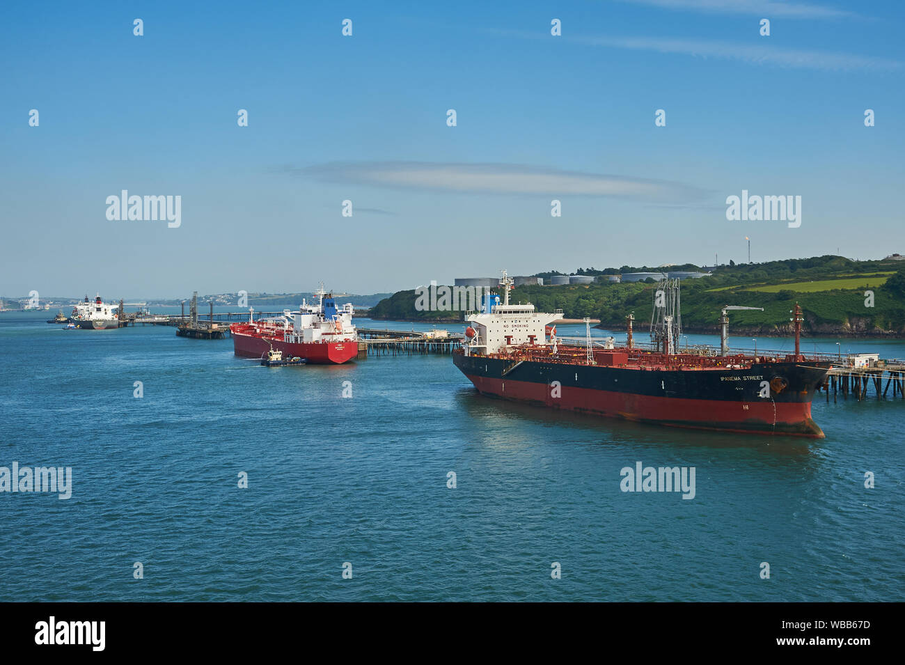 Oil and petro-chemical tankers moored to pontoons serving Milford Haven refineries in South Wales. Stock Photo