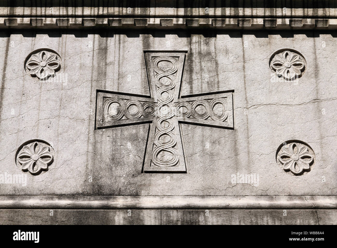 Milan, Italy. Old grave at Monumental Cemetery (Cimitero Monumentale). Religious art - Christian cross. Stock Photo