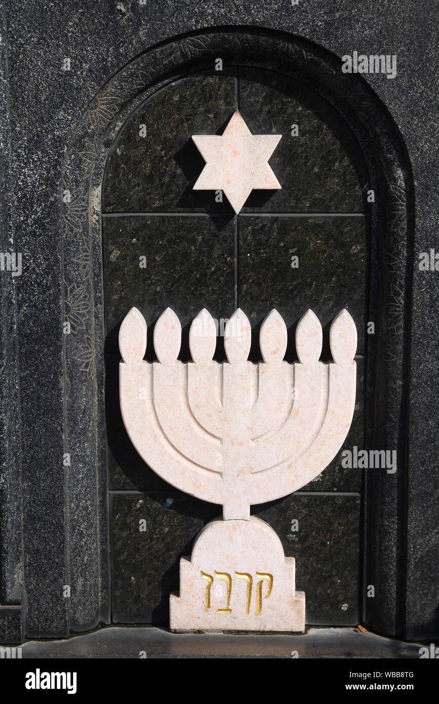 Menorah Jewish symbol in a grave stone in Milan Monumental Cemetery