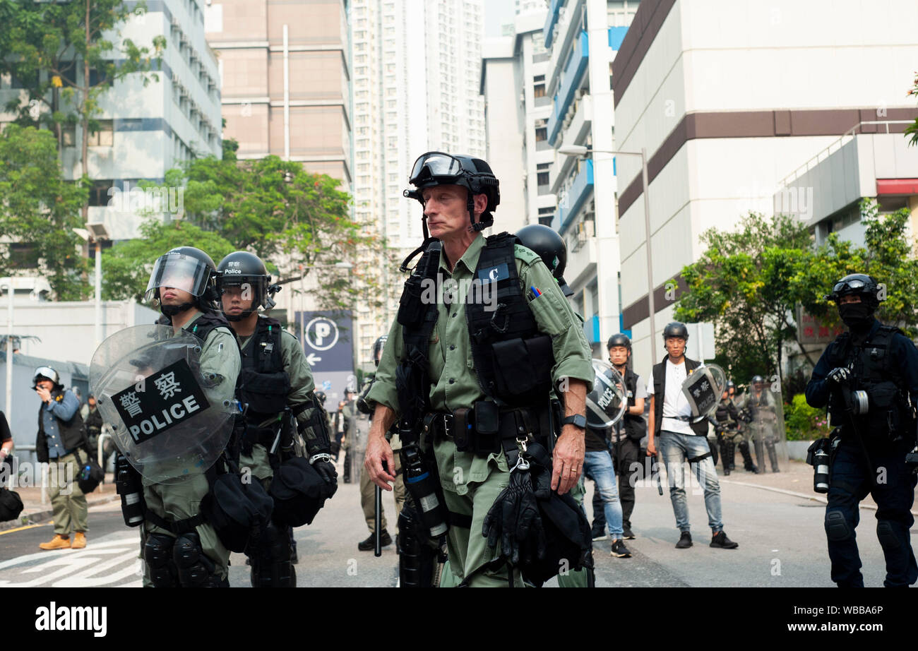 Hong Kong, China. 24th Aug, 2019. Riot police gather in formation in preparation to charge a large mass of pro-democracy protesters on the road in Kwun Tong. Pro-democracy protesters and police in riot gear clashed in Kwon Tong throughout the day. Police used rubber bullets, pepper ball guns, and tear gas to suppress the large crowd of protesters that continually set up barricades and hurled rocks and petrol bombs.Mass demonstrations continues for one more weekend in Hong Kong which began in June 2019 over a now-suspended extradition bill to China. Credit: SOPA Images Limited/Alamy Live News Stock Photo