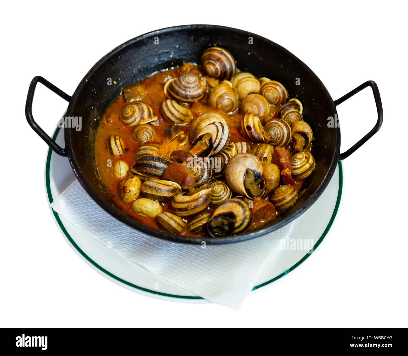 Appetizer of escargots stewed with chorizo served in black fry pan