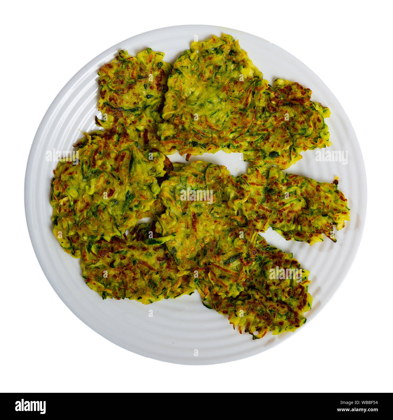 Zucchini pancakes with white sauce on withe plate. Isolated over white background Stock Photo