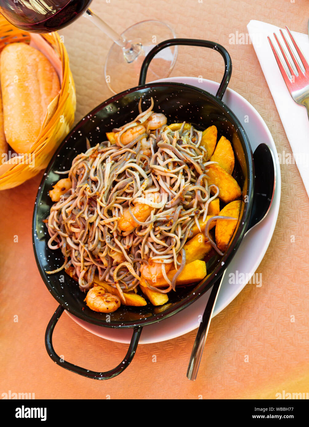 Spainsh dish seafood fried baby eels and prawns with potatoes, nobody Stock Photo