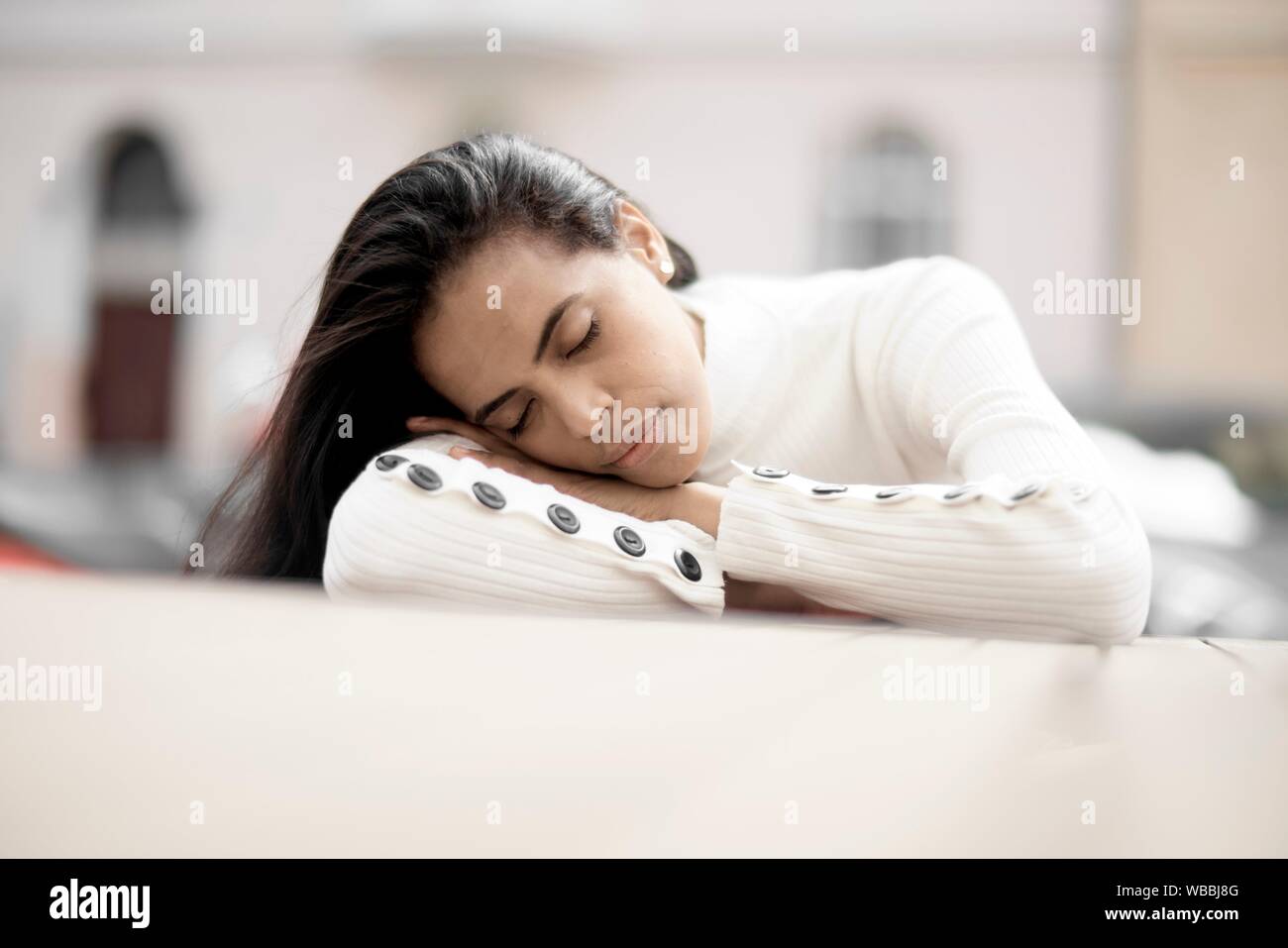 woman laying on table, eyes closed Stock Photo - Alamy