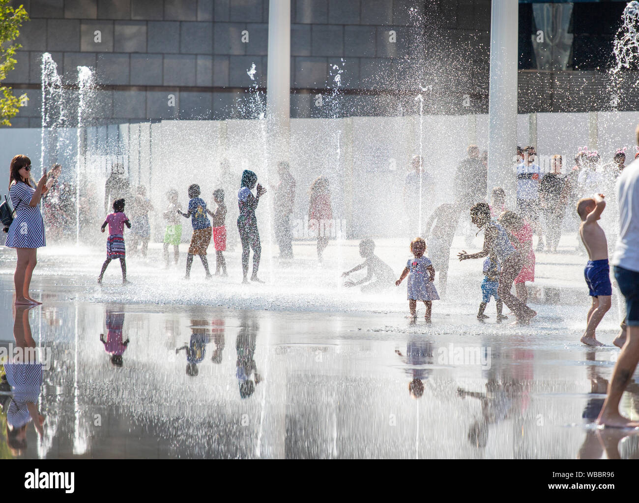 Children cooling off in fountains in Centenary Square, Birmingham, UK, on the hottest August Bank Holiday on record Stock Photo