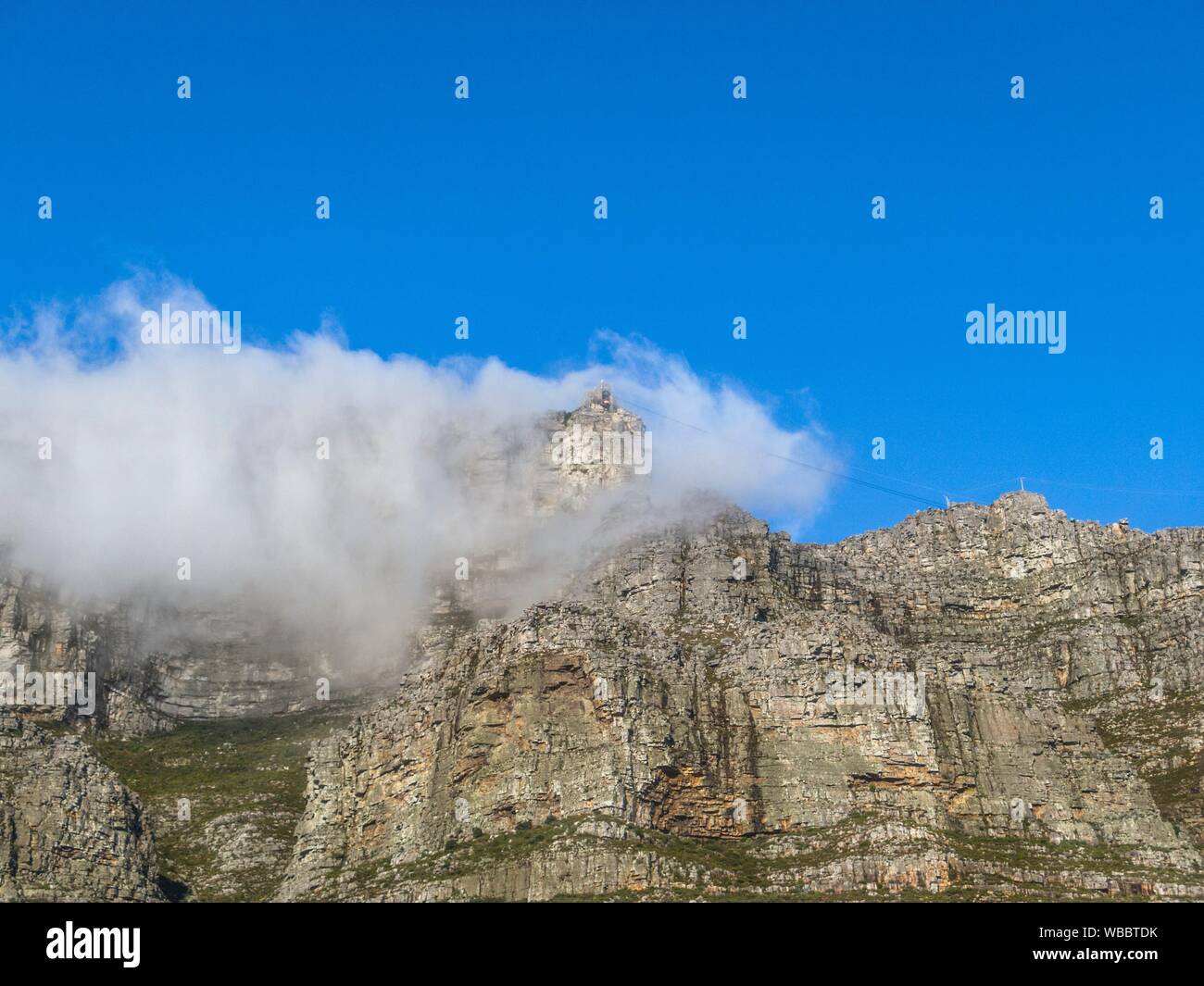 Table Mountain covered by by clouds during a strong South East wind. This is know as The Tablecloth that covers the table. Stock Photo