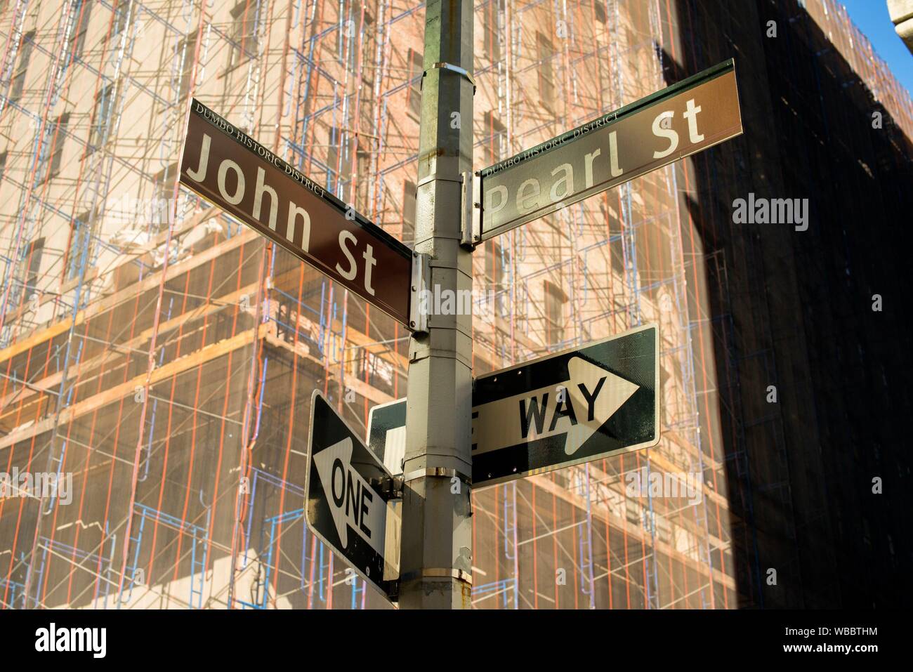 New York City, USA. View on streetsign with streetnames and building under reconstruction. Stock Photo
