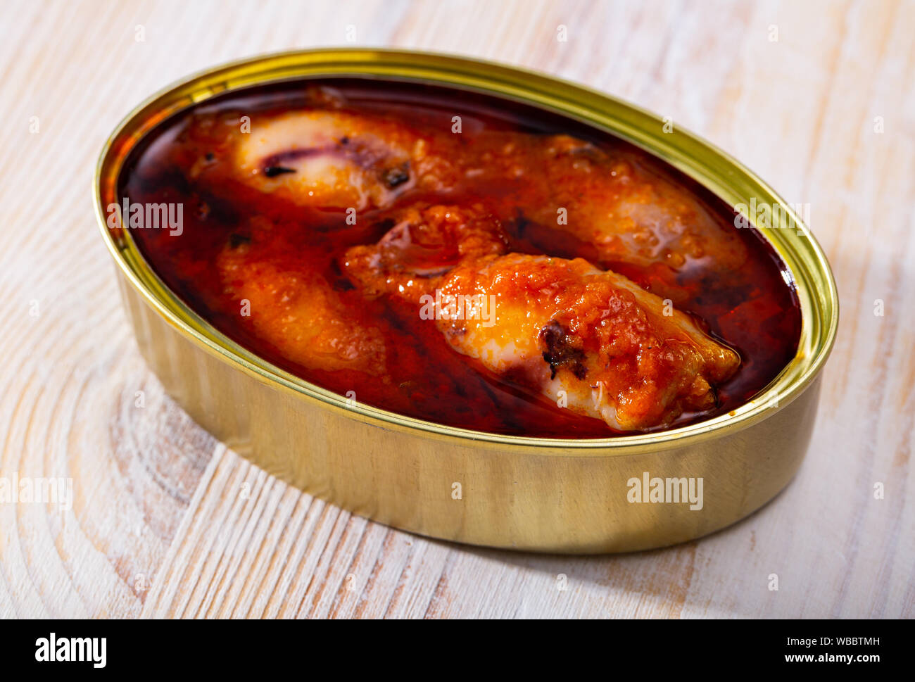 Image of canned stuffed squid in American sauce in open tin can, nobody Stock Photo