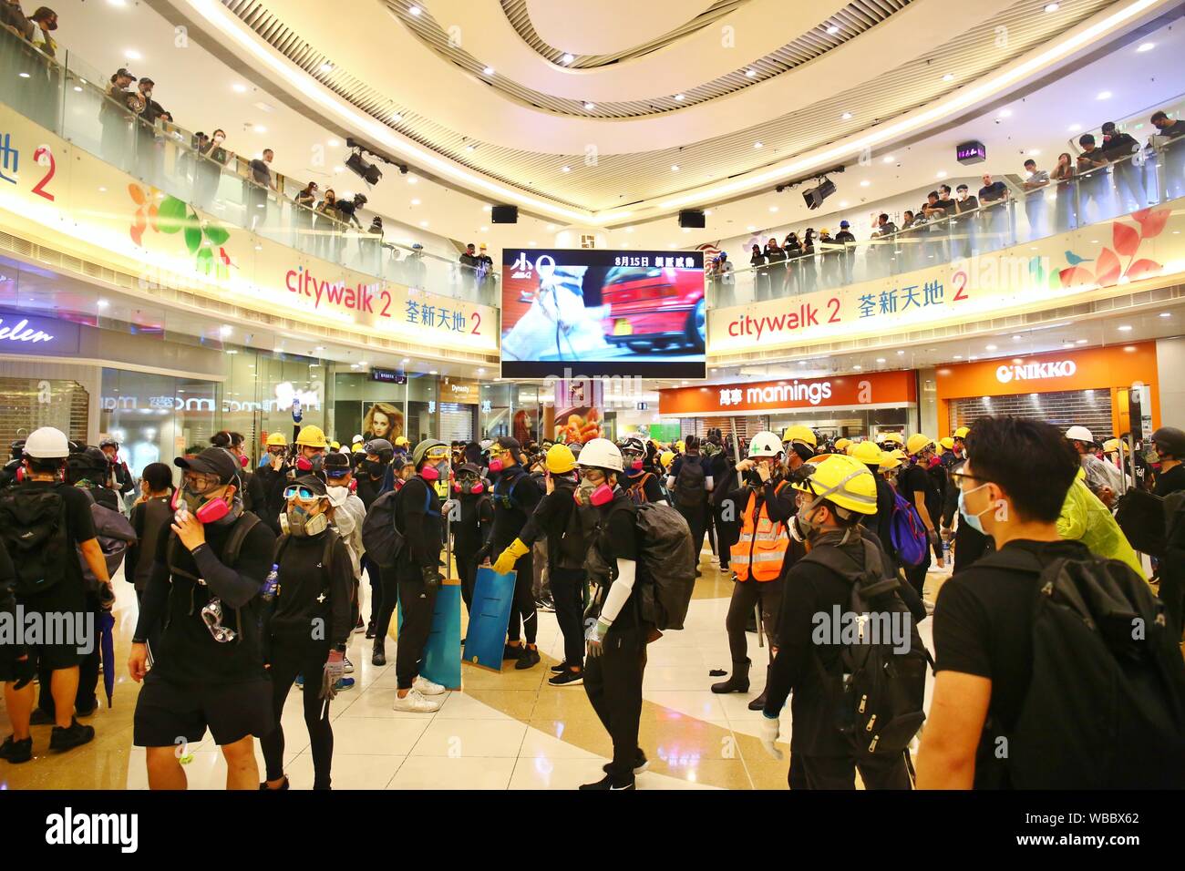 Hong Kong, China. 25th Aug, 2019. A peaceful rally turns violent with several clashes between protesters and police at Tsuen Wan. Protesters retreat back to the city mall when the police pushes forward to disperse the crowds Credit: Gonzales Photo/Alamy Live News Stock Photo