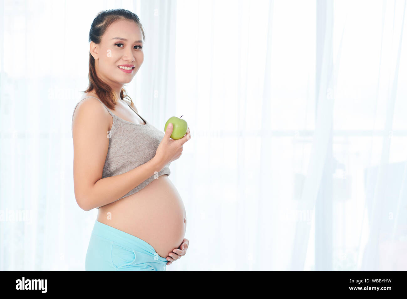 Happy young Vietnamese pregnant woman eating delicious healthy ... Happy young Vietnamese pregnant woman eating delicious healthy ...