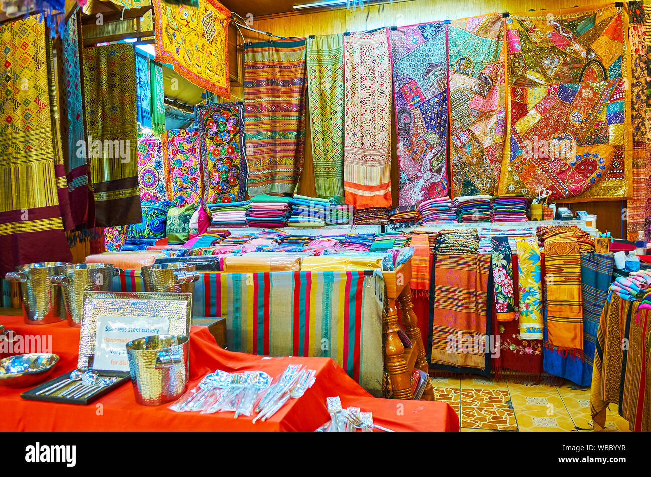 The stall of Kalare Night Market with wide range of colorful fabrics of cotton, silk and synthetic materials, decorated with prints, embroideries, pat Stock Photo