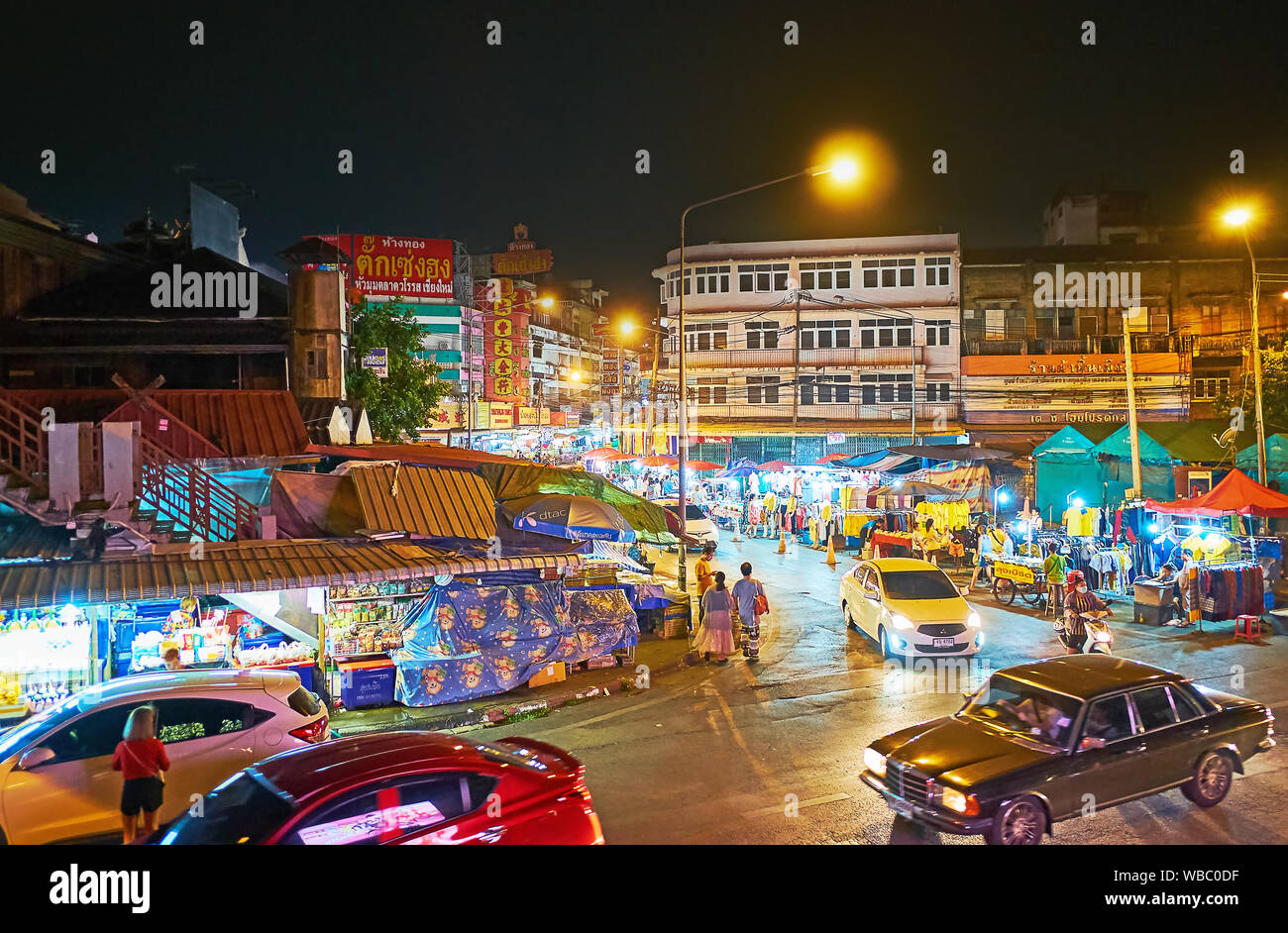 CHIANG MAI, THAILAND - MAY 2, 2019: The busy Praisanee Road at the Warorot Night Market with its numerous illuminated stalls and street vendors, on Ma Stock Photo