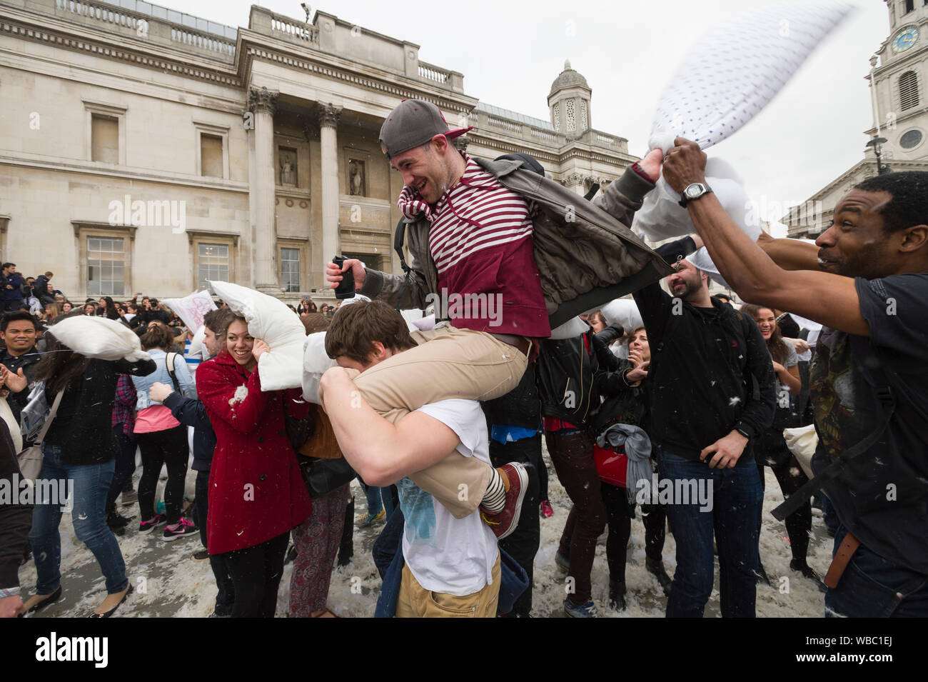 People taking part in, International Pillow Fight Day, Trafalgar Square, London, Britain. Pillow fights are happening in different city all round the Stock Photo