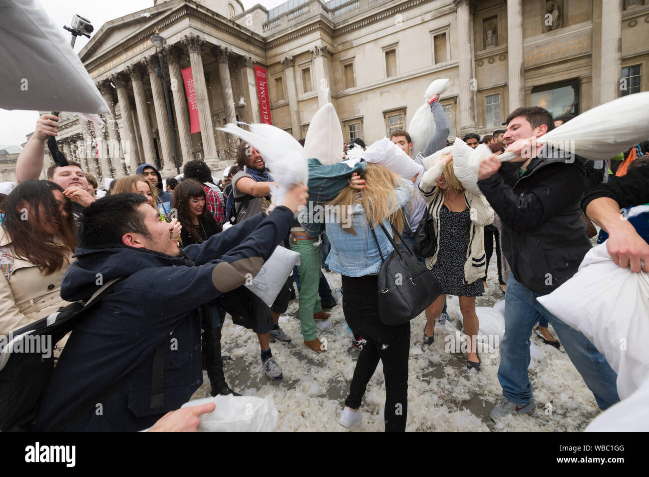 People taking part in, International Pillow Fight Day, Trafalgar Square, London, Britain. Pillow fights are happening in different city all round the Stock Photo