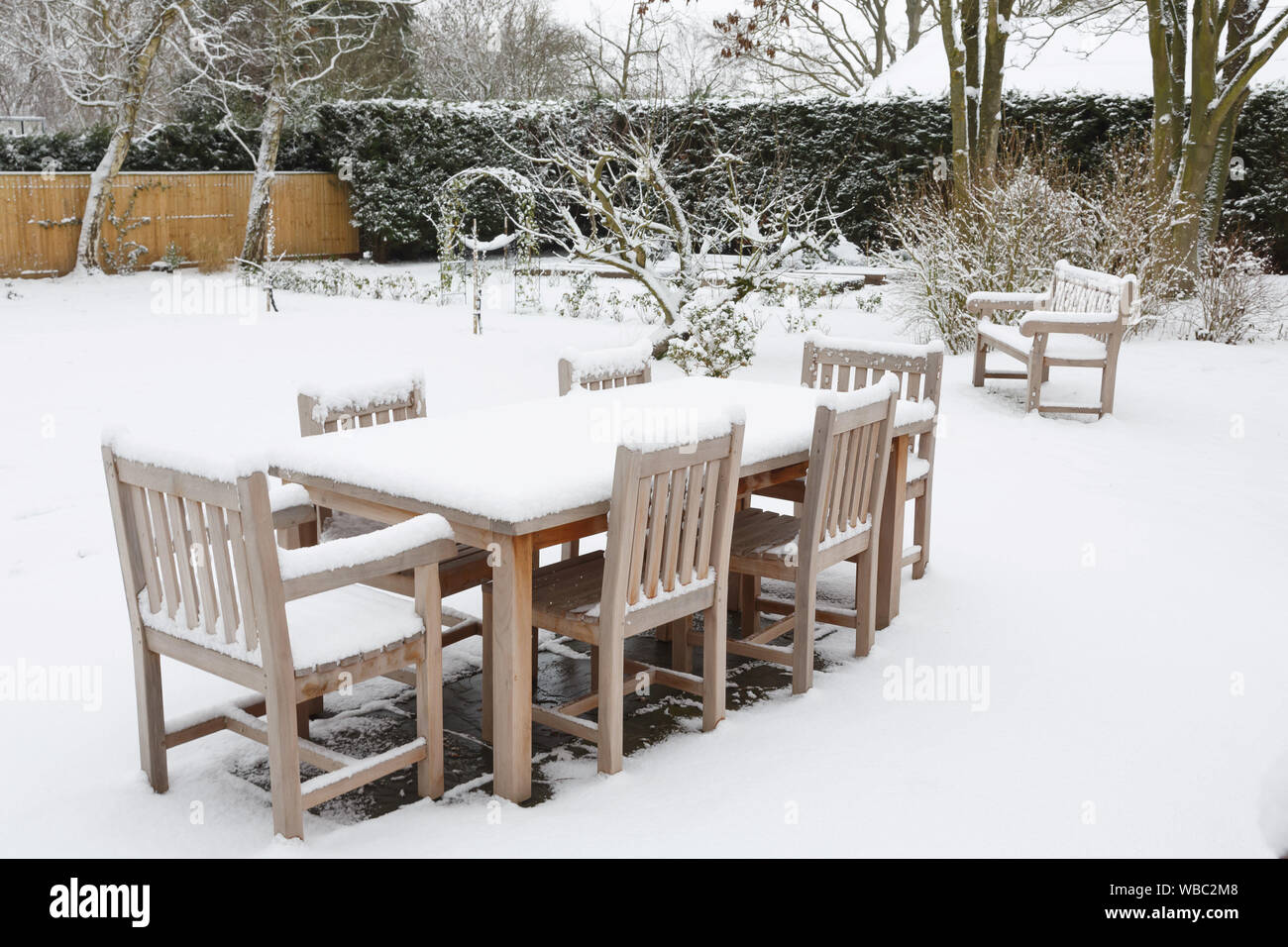 Patio garden furniture covered with snow in winter, UK Stock Photo