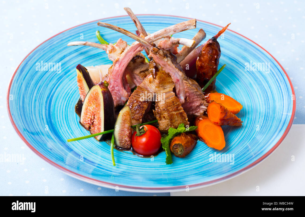 Image of tasty lamb ribs baked and served with vegetables and fresh