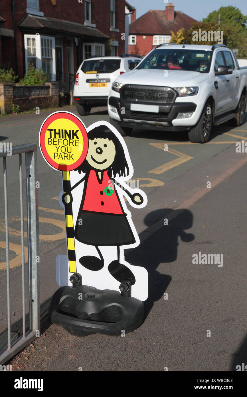 A sign outside an infants’ school to try to persuade parents to think before they park and to park in a safe place Stock Photo