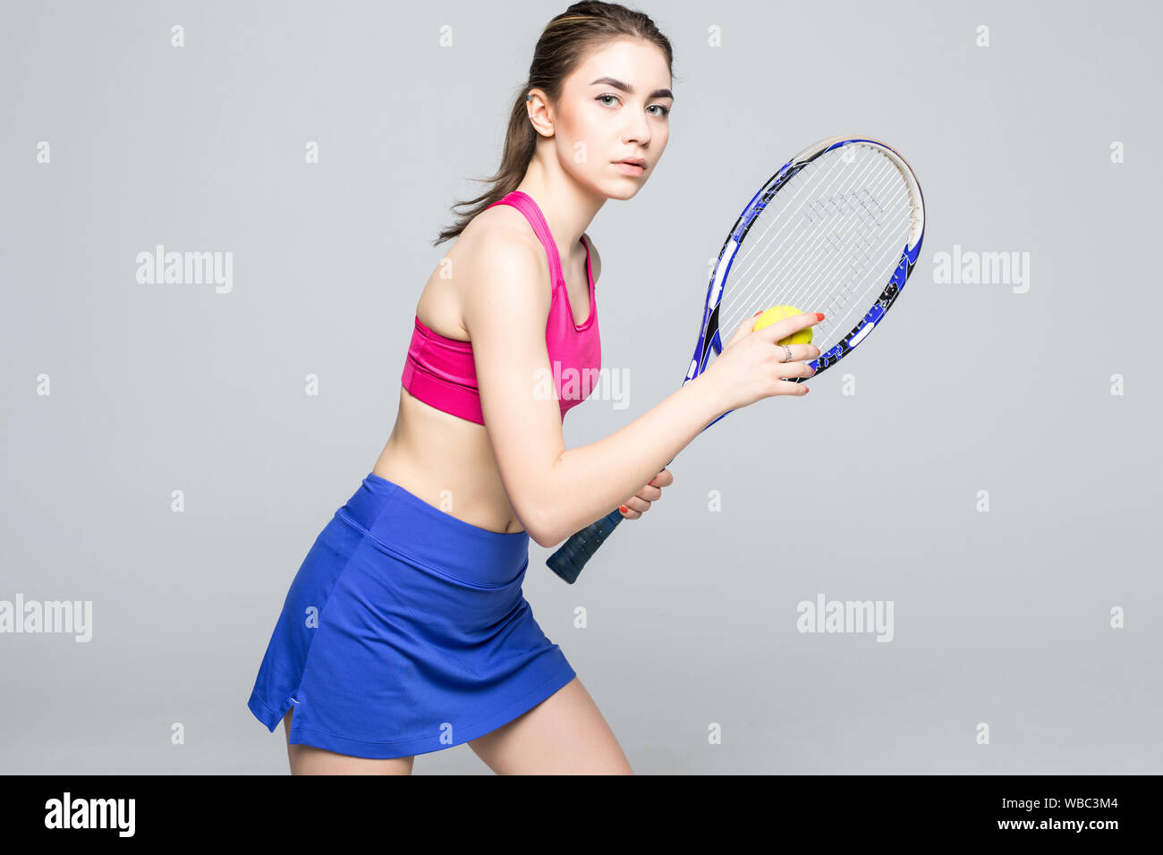 Full length portrait of female tennis player serving ball Stock Photo