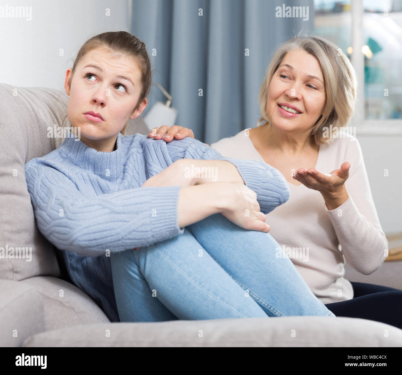 Mature mom apologizes to daughter after quarrel Stock Photo