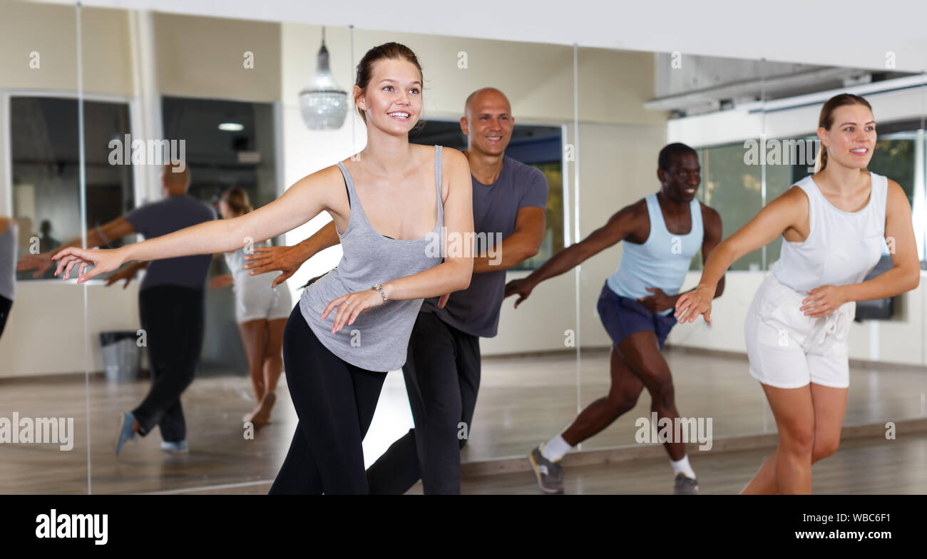 Group of multinational positive people practicing new dance techniques in modern class Stock Photo
