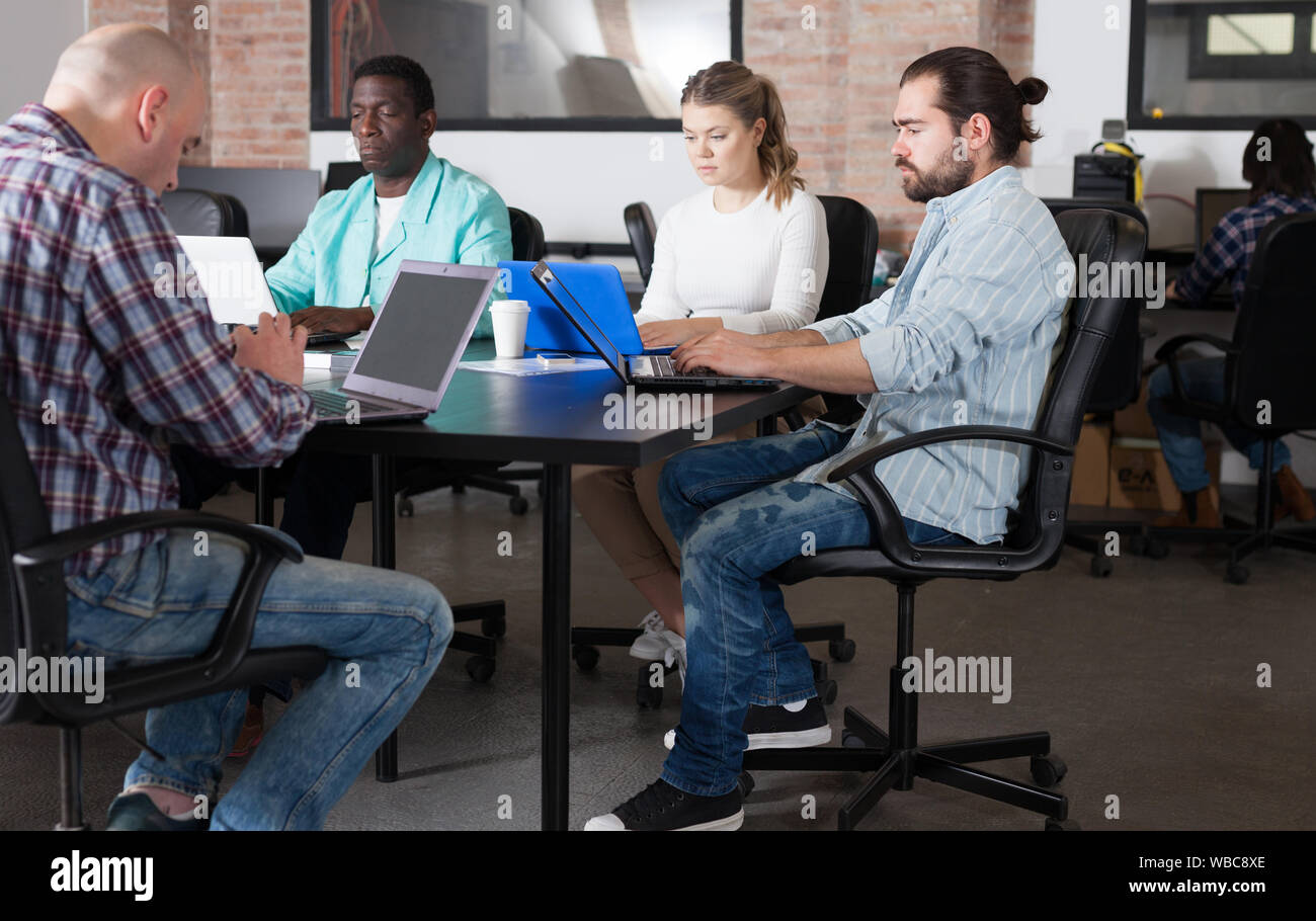 Multiethnic startup business team working on new project in loft style coworking space Stock Photo