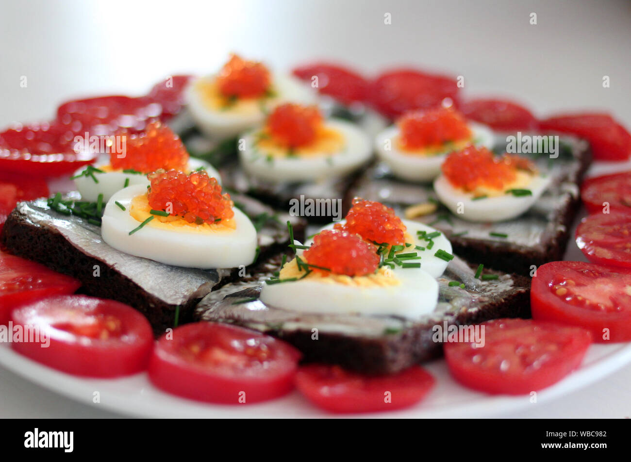 Rye bread sandwich with fish, egg and dill and caviar.Estonian
