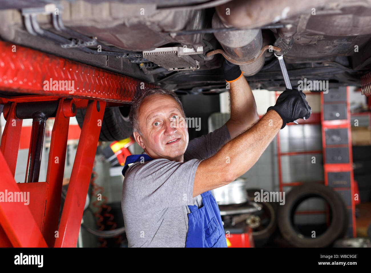 Professional mature man car mechanician repairing car in auto repair shop Stock Photo Alamy