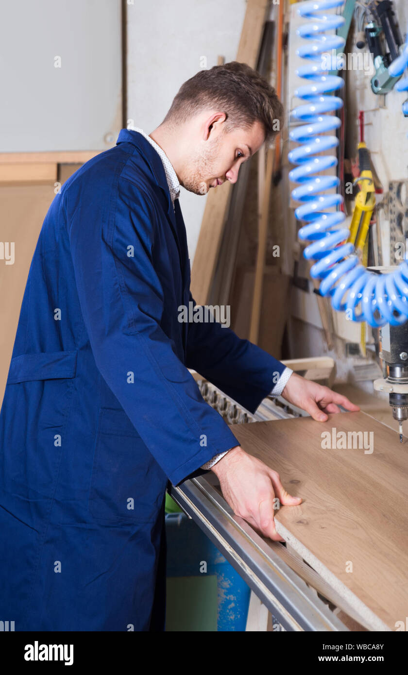 american guy using drilling machine at workshop Stock Photo