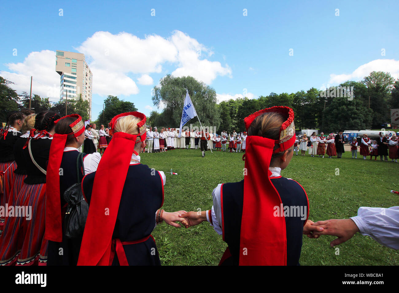 Tallinn, Estonia - 7.03.2011 - folk dancers celebrating their performance at Estonian national song and dance festival by holding hands and forming a Stock Photo