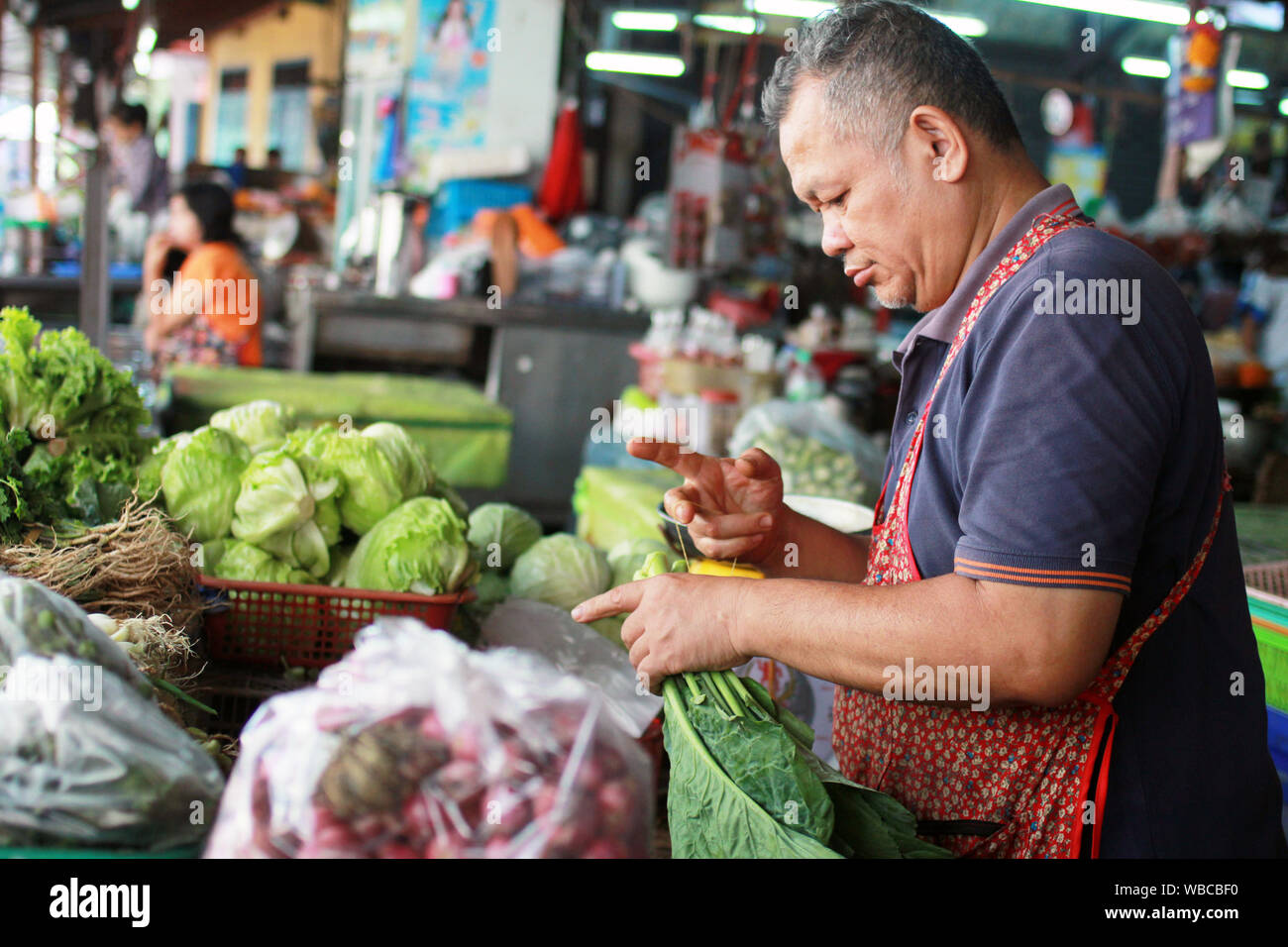 Bangkok, Thailand - 11.04.2015 - seller at fruit and vegeable market Stock Photo